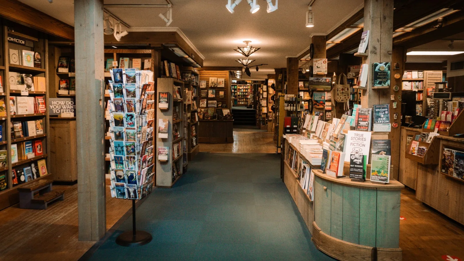Wood-beamed interior of Northshire Bookstore in Manchester Center, Vermont, lined with book displays.
