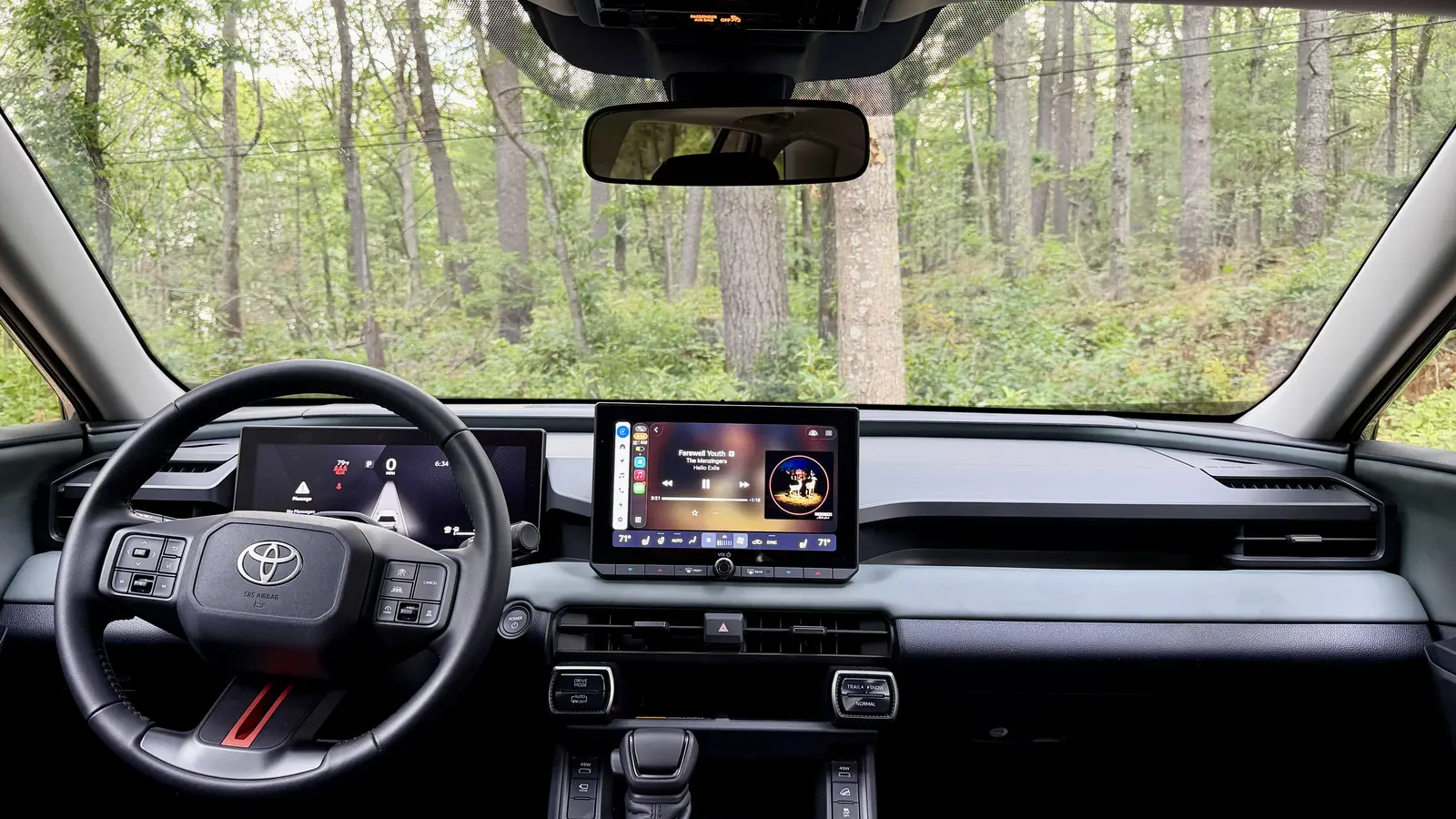 Interior of the 2026 Toyota RAV4 Plug-in Hybrid showing the steering wheel, digital gauge cluster and center touchscreen