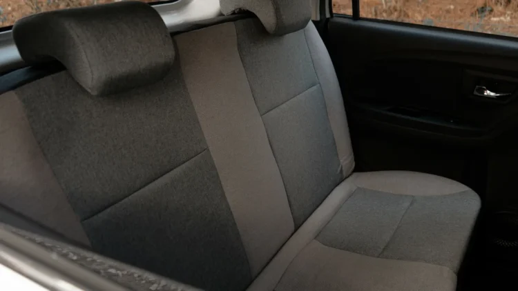 Gray two-tone cloth rear bench seat with two headrests inside a Wink Mark3 electric microcar.